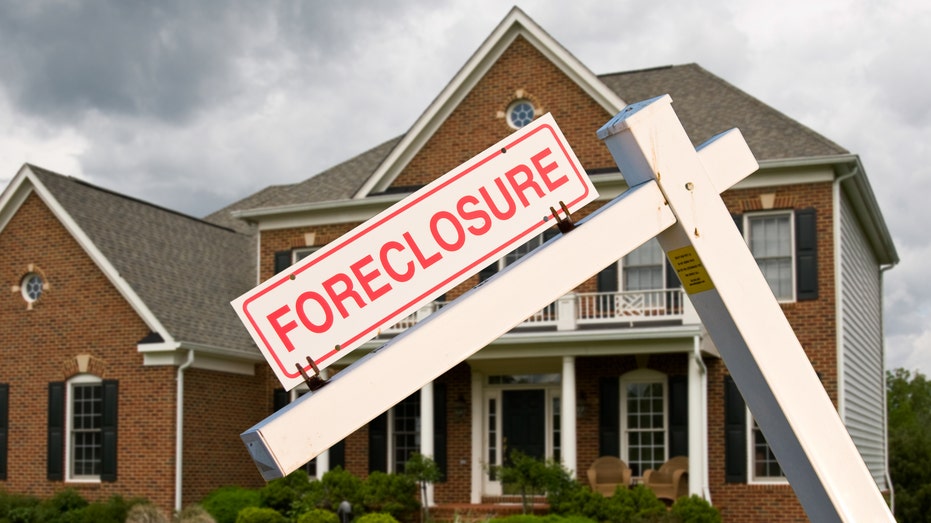 Foreclosure sign in front of house stock image