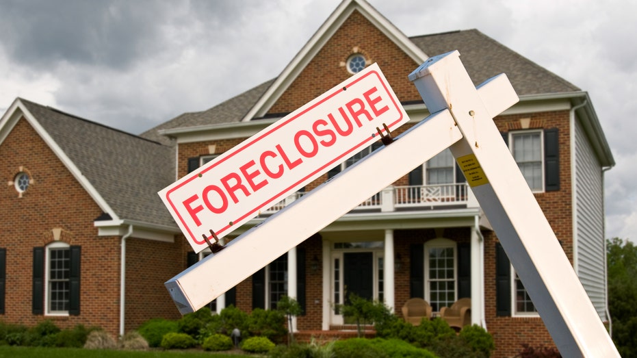 Foreclosure sign in front of house stock image