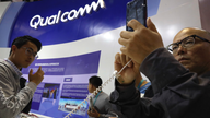 The Latest: Qualcomm defeat might not lower phone prices