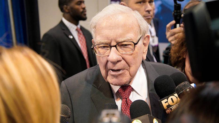 Warren Buffett’s Berkshire reports a loss of  billion as the value of its investments falls