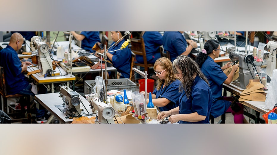 Factory workers making shoes