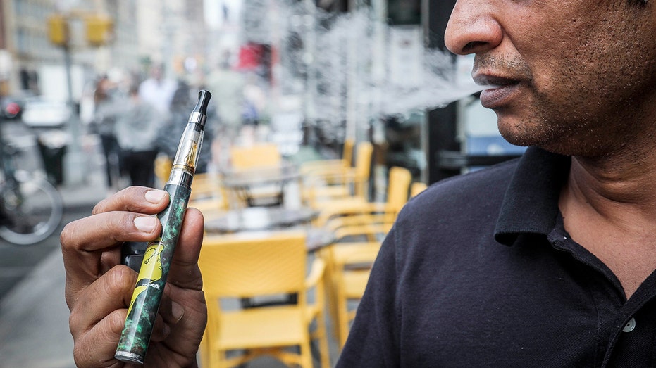 A man vapes in New York City,