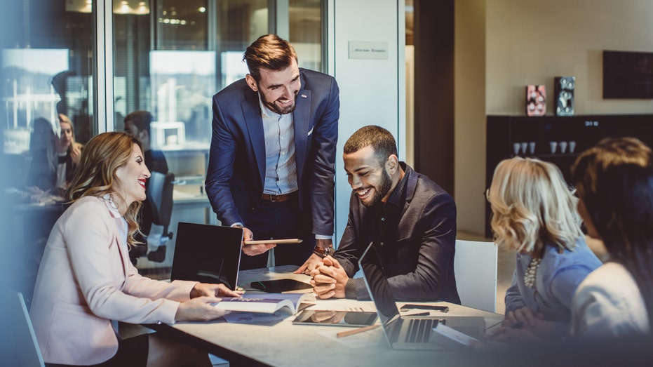 Colleagues working in office together