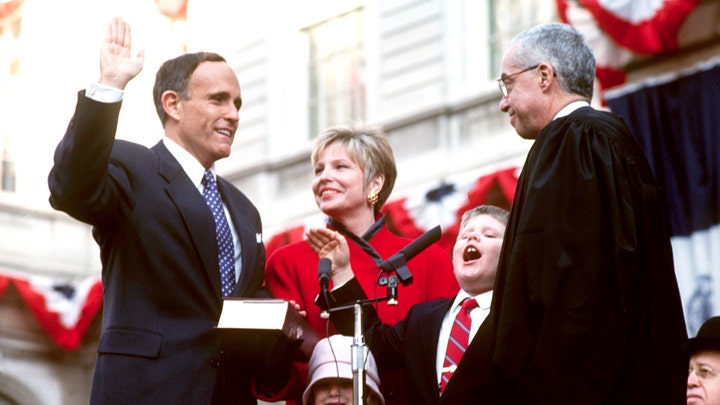 Rudolph Giuliani, alongside his then-wife Donna Hanover, is sworn in as 107th Mayor of New York City, 2nd January 1994. (Photo by Mark Peterson/Corbis SABA/Corbis via Getty Images)