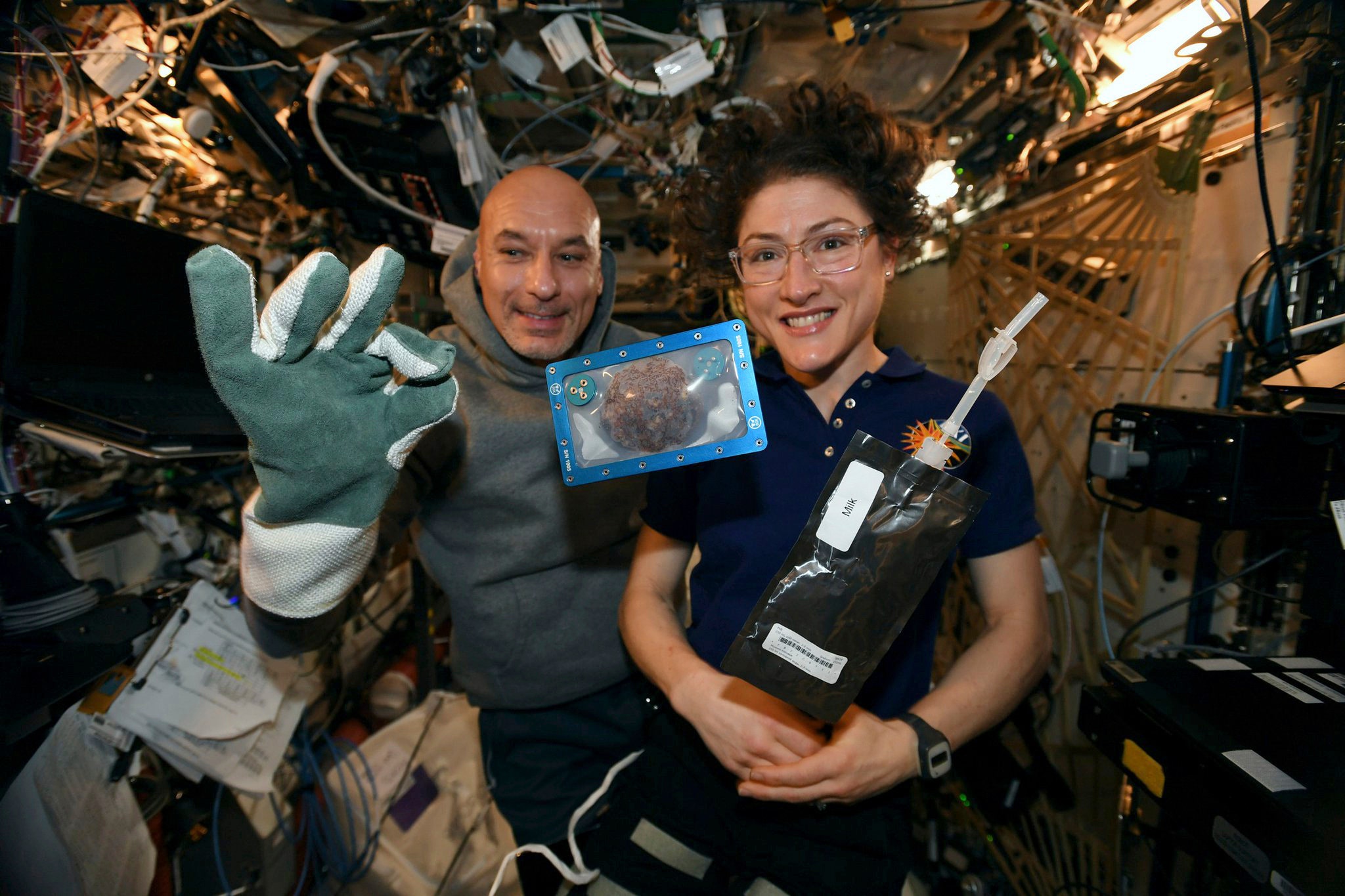 Astronauts holding cookies baked in space