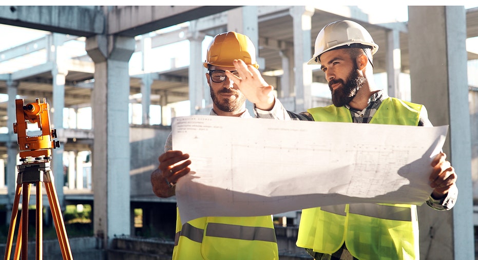 Workers reading blueprints