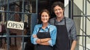 Small business owners stand outside their local store. - Fox Business News