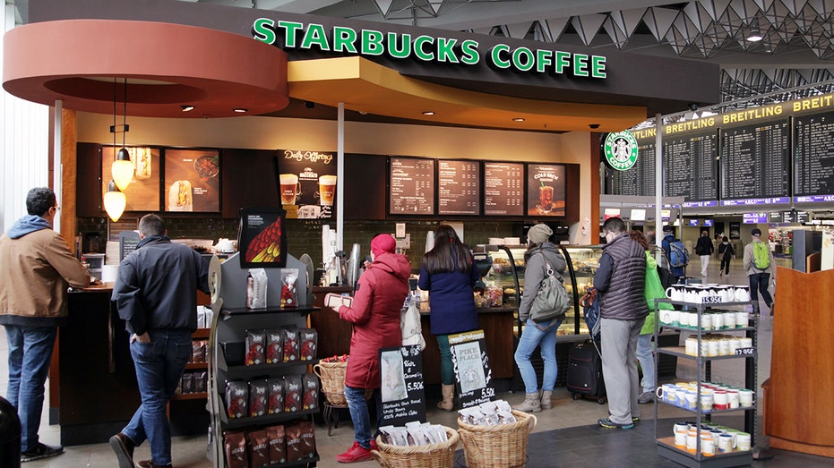 Line forms at a Starbucks location at an airport