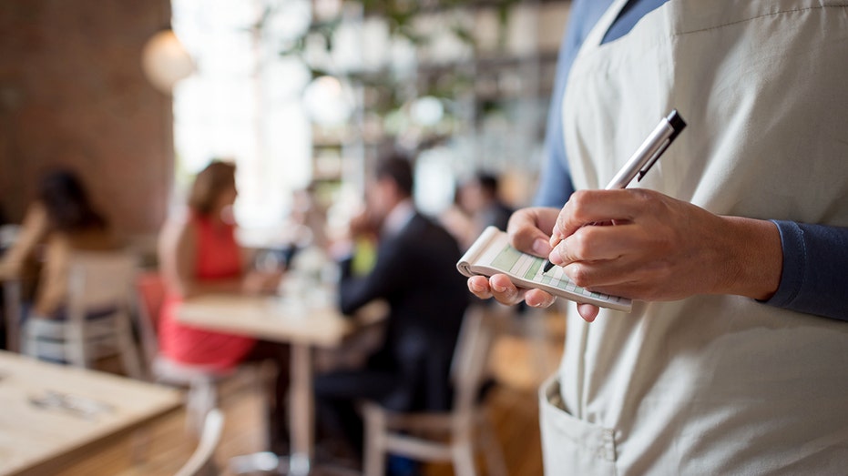 A waiter works in the service sector