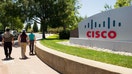 Pedestrians walk past Cisco Systems Inc. signage displayed outside of the company's headquarters in San Jose, California, U.S., on Tuesday, July 12, 2011. Cisco Systems Inc., the largest networking-equipment company, may cut as many as 10,000 jobs, or about 14 percent of its workforce, to revive profit growth, according to two people familiar with plans. Photographer: David Paul Morris/Bloomberg via Getty Images - Fox Business News