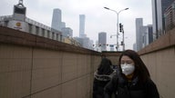 Mask-clad Chinese workers cautiously return to the office