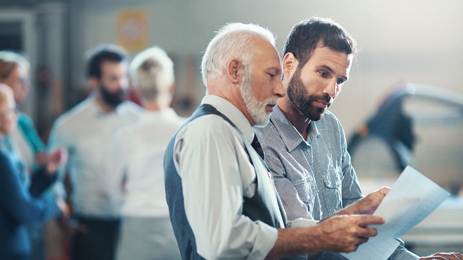 workers reviewing an issue together