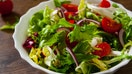 various fresh mix salad leaves with tomato in bowl on wooden background - Fox Business News