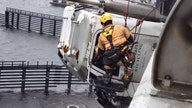 Virginia truck driver rescued from cab dangling 70 feet over river: PHOTOS