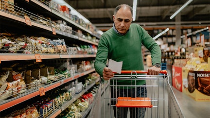 Mature man with a shopping list buying groceries in the supermarket - Fox Business News
