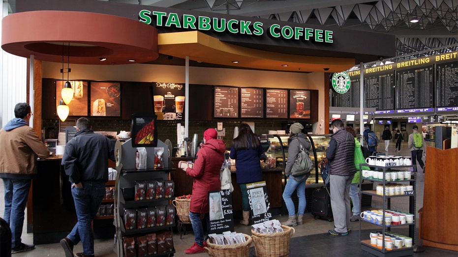 Coffee drinkers waiting for beverages at Starbucks location at an airport