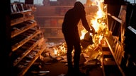 Stock futures trade cautiously as riots grip America