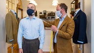 With face visors and gloves, London's bespoke tailors reopen