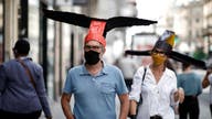 Coronavirus social distancing for Paris gallery achieved with 'deconfinement' hats