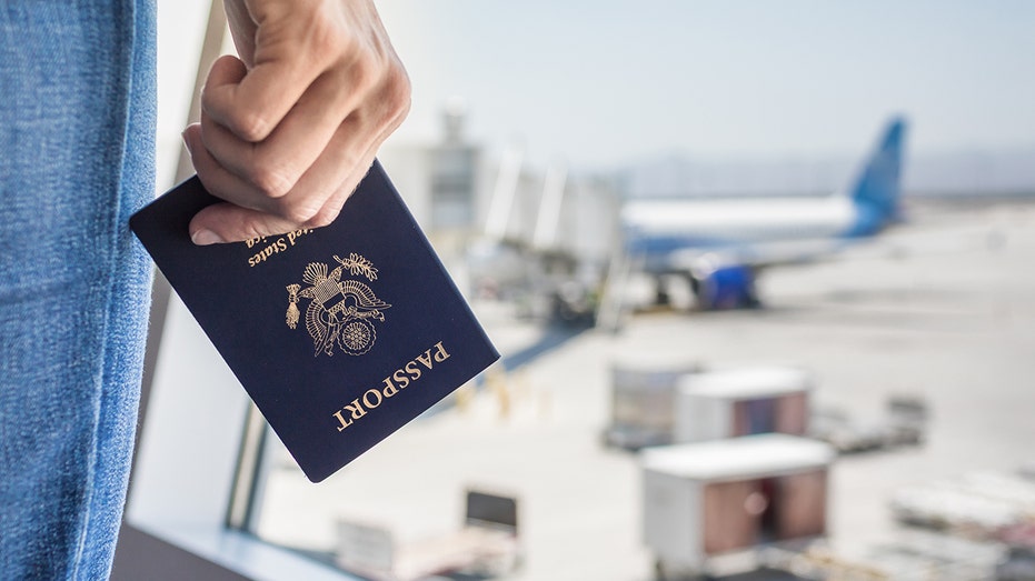 woman holds passport at airport