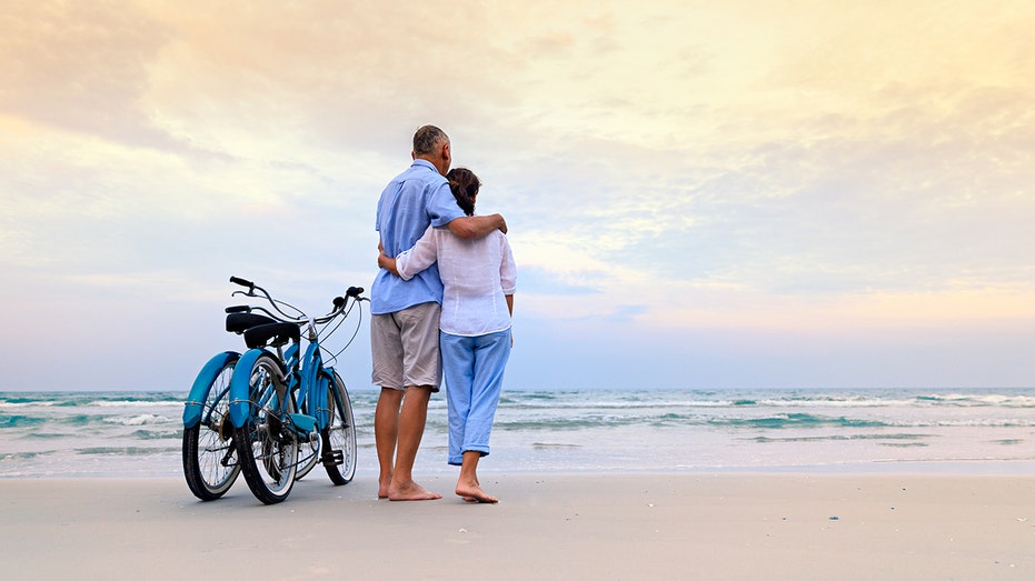 active couple riding bikes, retirement 