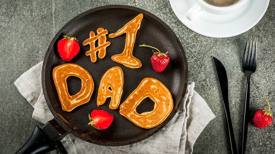 Number 1 Dad spelled out in pancakes on a black plate