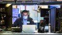 In this photo provided by the New York Stock Exchange, trader Aman Patel wears a protective face mask as he works on the partially reopened trading floor, Tuesday, May 26, 2020. Stocks surged on Wall Street in afternoon trading Tuesday, driving the S&amp;P 500 to its highest level in nearly three months, as hopes for economic recovery overshadow worries about the coronavirus pandemic. (Colin Zimmer/New York Stock Exchange via AP)