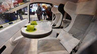 Auto makers rethink the car with swivel seats, self-cleaning buttons and window art