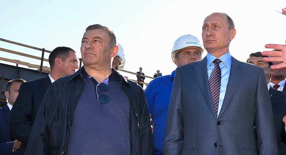 In this Sept. 15, 2016, file photo, Russian President Vladimir Putin, right, joins businessman and billionaire Arkady Rotenberg during to a visit to the construction site of the Kerch Strait bridge in Kerch, Crimea. 