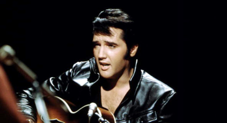 Elvis Presley performs with guitar