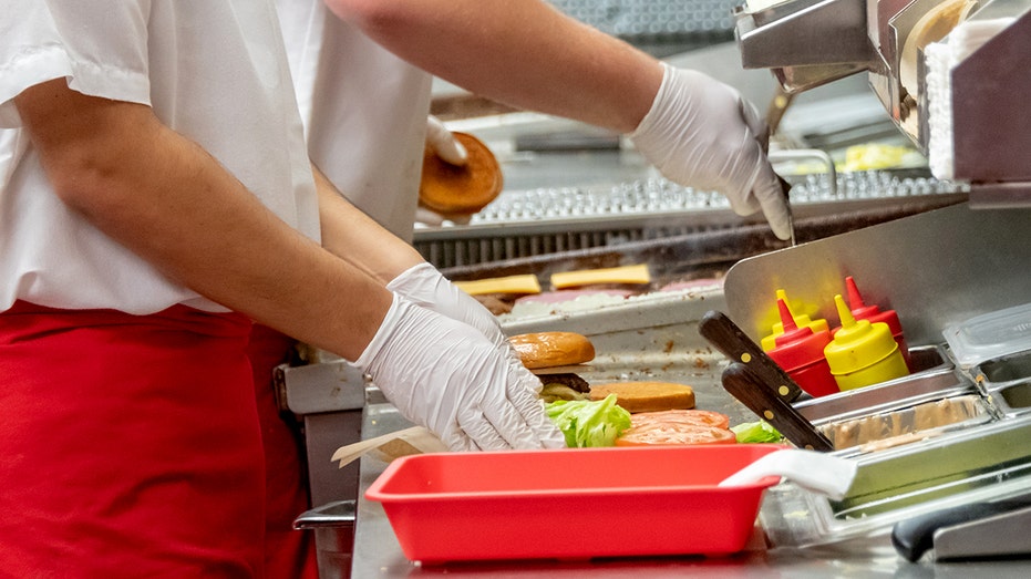 Fast food worker makes burger