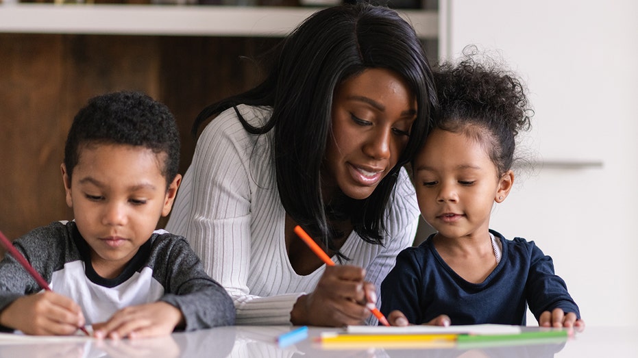 mom with kids doing schoolwork