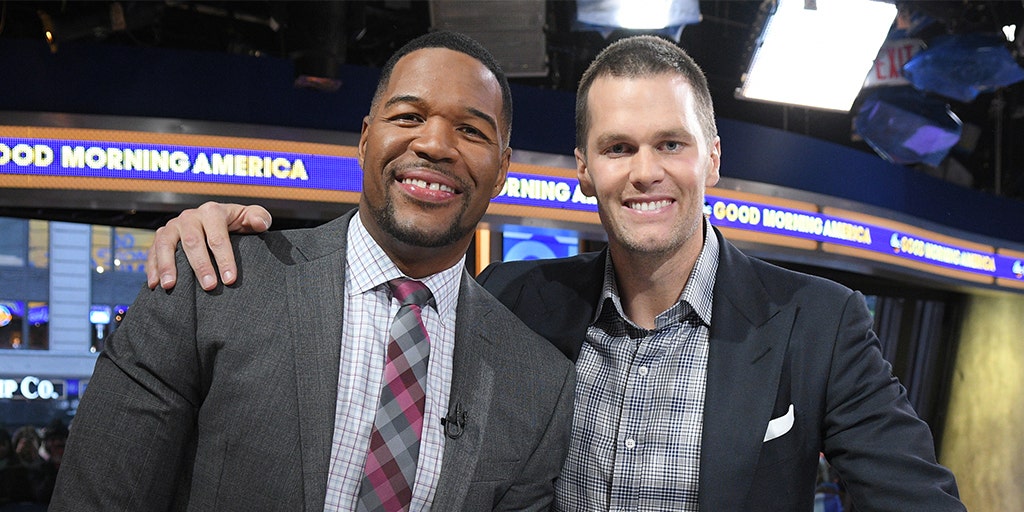 LOOK: Michael Strahan can't help but sack Tom Brady off the field