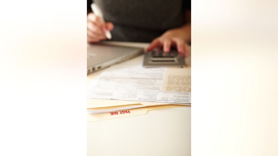 woman paying past due bills