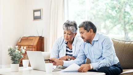 A couple reviews their finances at home.