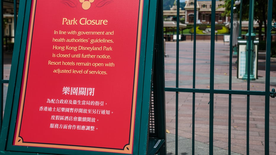 A notice of closure stands at the entrance to Walt Disney Co.'s Disneyland Resort, temporarily closed due to the coronavirus, in Hong Kong, China, on Wednesday, July 15, 2020. 