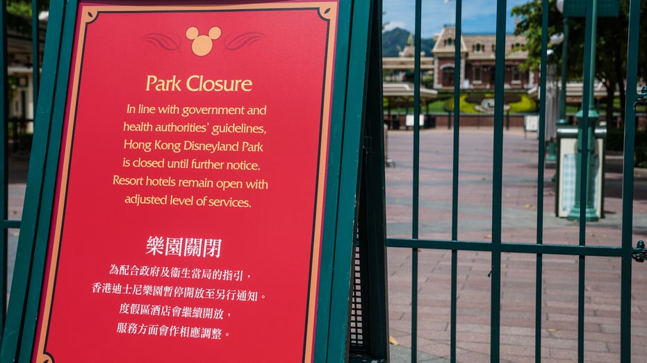 A notice of closure stands at the entrance to Walt Disney Co.'s Disneyland Resort, temporarily closed due to the coronavirus, in Hong Kong, China, on Wednesday, July 15, 2020. 