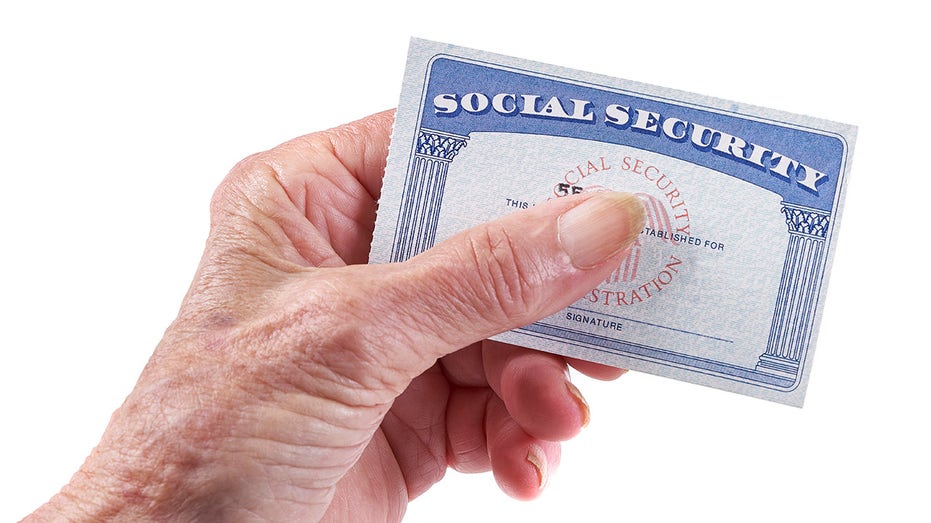 Social Security Card: Senior woman holding card in hand on white background