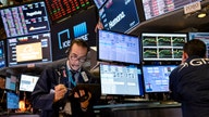 Stock futures trade cautiously as earnings parade continues