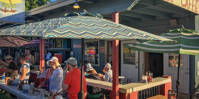 Kihei, HI, USA - 2013 November 9, 2016: Incidental people enjoying breakfast at Kihei Caffe across from Kalama Beach Park on the Hawaiian island of Maui, USA