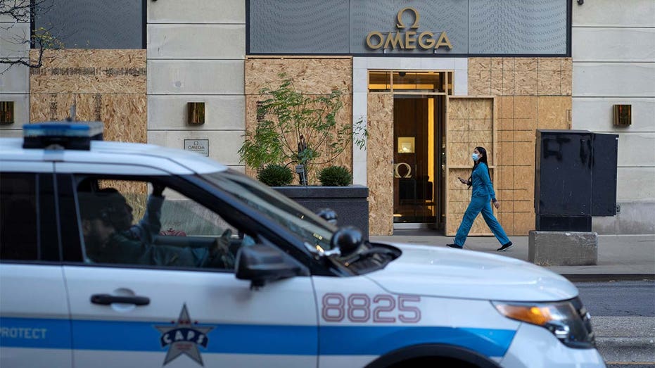 Plywood covers the windows of an Omega store in Chicago. 