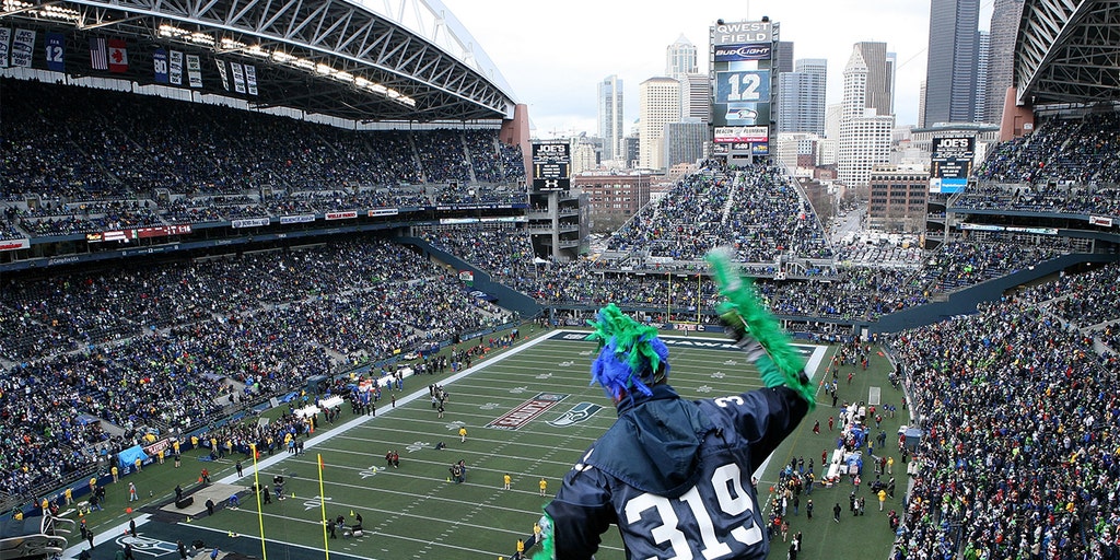 Seattle Seahawks mascot, Blitz, console Seattle Seahawks quarterback  Russell Wilson (3) as he departs the field after their 31-34 loss to the  Arizona Cardinals at CenturyLink Field in Seattle, Washington on December