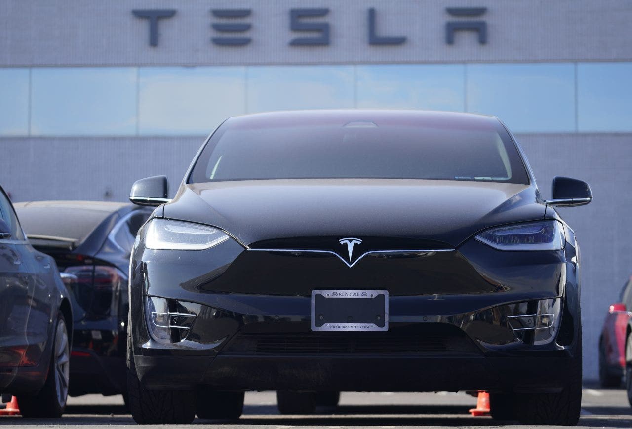 Tesla reports first profitable year after sixth consecutive quarter of earnings