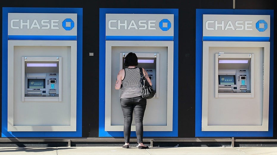 OAKLAND, CA - OCTOBER 13: A customer uses an ATM outside of a Chase bank office on October 13, 2011 in Oakland, California. JPMorgan Chase & Co. a nearly 33 percent decline in third quarter profits with earnings of $3.1 billion compared to $4.71 billion one year ago. (Photo by Justin Sullivan/Getty Images)