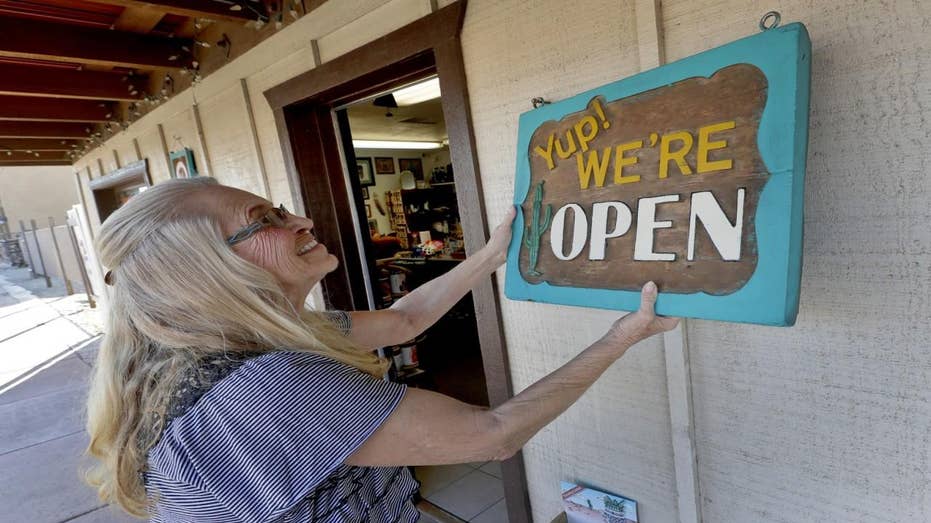 Woman flips store sign over