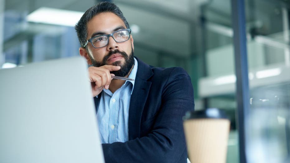 Man thinking at work desk