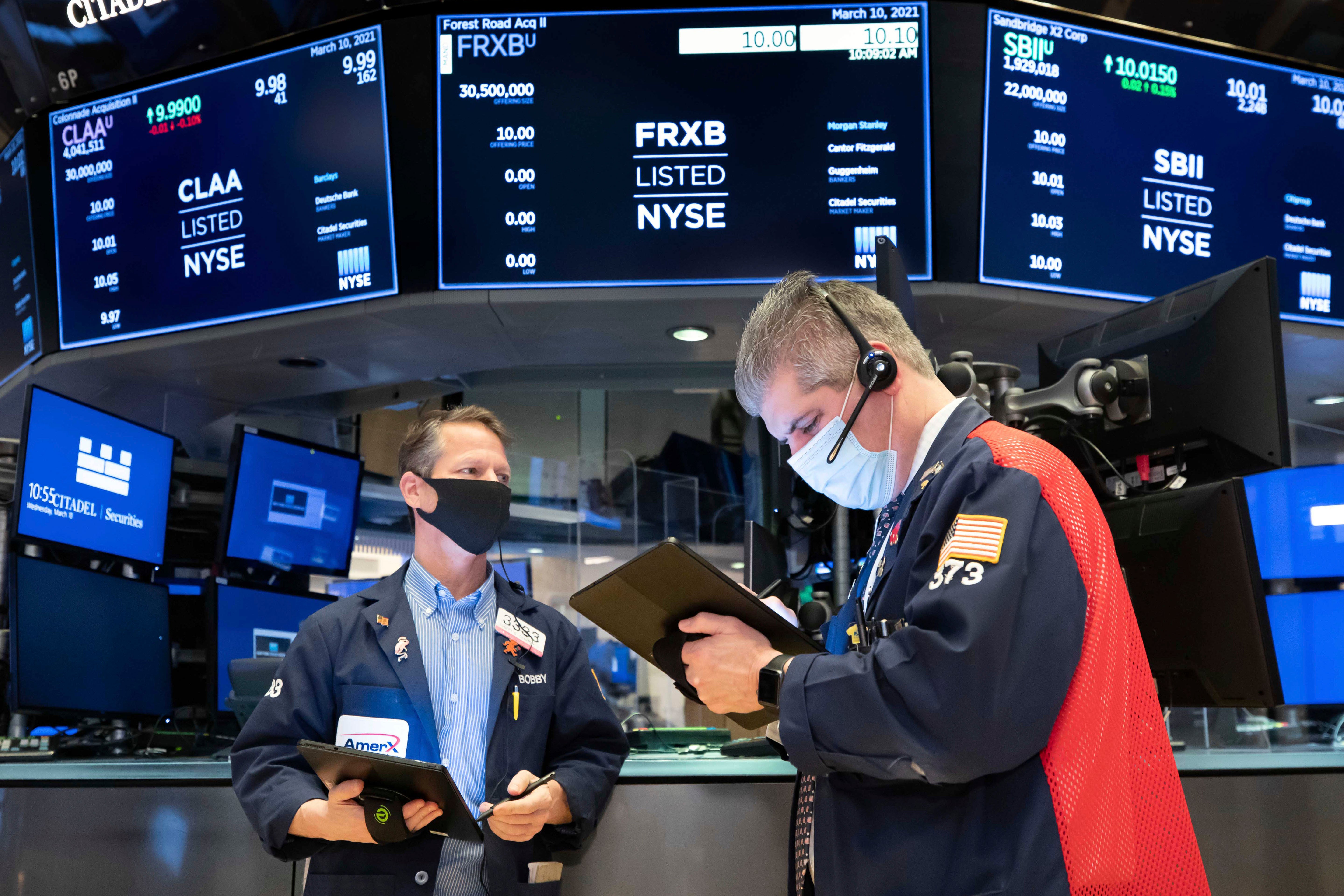 Stocks traded earlier one day after 33,000 plateaus, Fed insurance