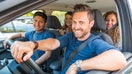 Happy smiling people sharing car ride - multicultural group of friends leaving for a trip together or sharing the ride to reduce emissions - sharing economy as well as friendship concepts - Fox Business News