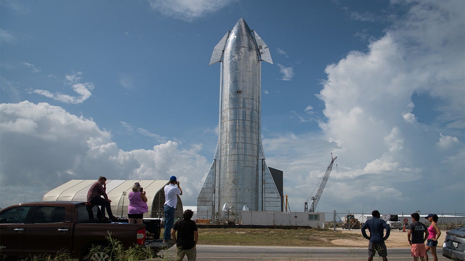 Space enthusiasts look at a prototype of SpaceX's Starship spacecraft at the company's Texas launch facility on Sept. 28, 2019, in Boca Chica near Brownsville, Texas. 