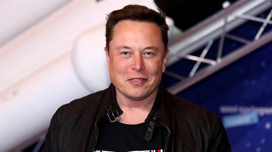 Elon Musk smiling at an event